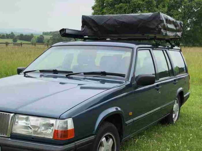 Closed roof tent mounted to the top of a car in the UK.