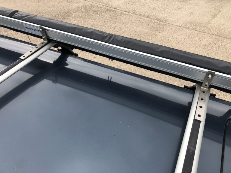 Side awning in position ready to be bolted to roof bars on an estate car in the UK.