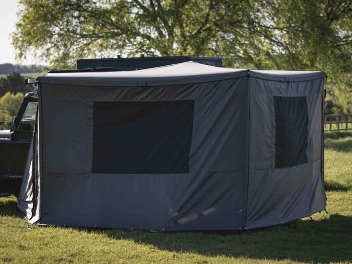 A 270 side awning with walls, making a fully enclosed room on a 4x4 in a field in the UK.