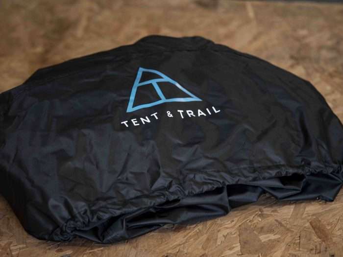 Roof tent protective cover folded up on a wooden table in the UK.